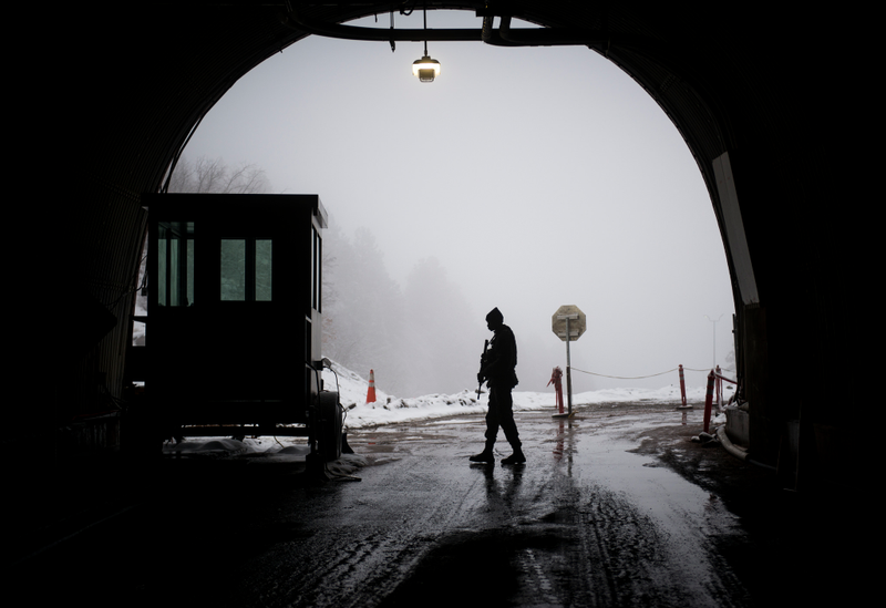 Senior Airman Ricardo Collie, a 721st Security Forces member, patrols the north gate of the Cheyenne Mountain Complex at Cheyenne Air Force Station, Colorado. Collie is one of many security layers to enter more than a mile inside a Colorado mountain to a complex of steel buildings that sit in caves. (U.S. Air Force photo/Staff Sgt. Andrew Lee)